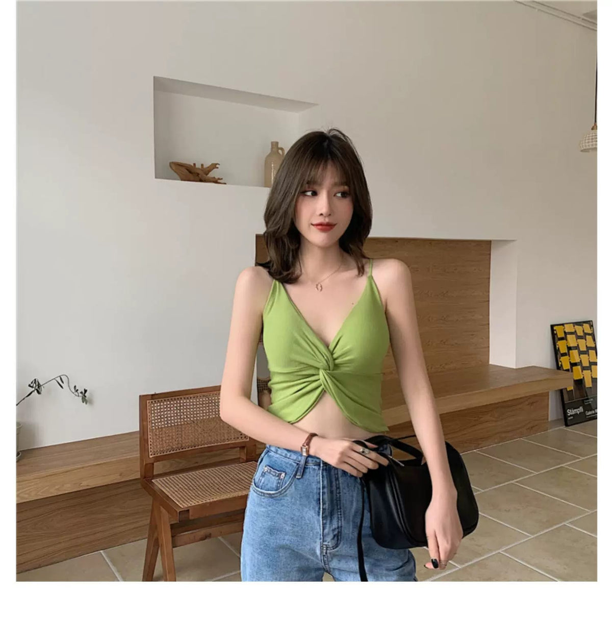 Green padded bralette styled with high-waisted blue jeans