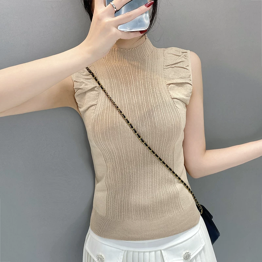 Beige sleeveless knit top showing ruffled shoulder detail and ribbed hem
