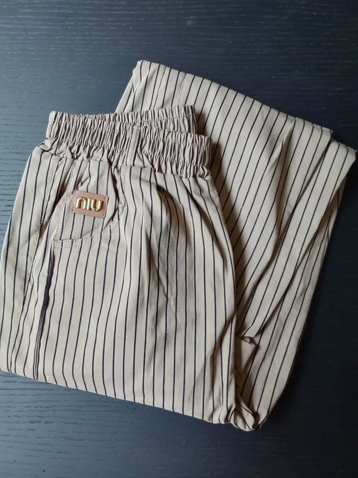 Folded striped pants showing elasticated waistband