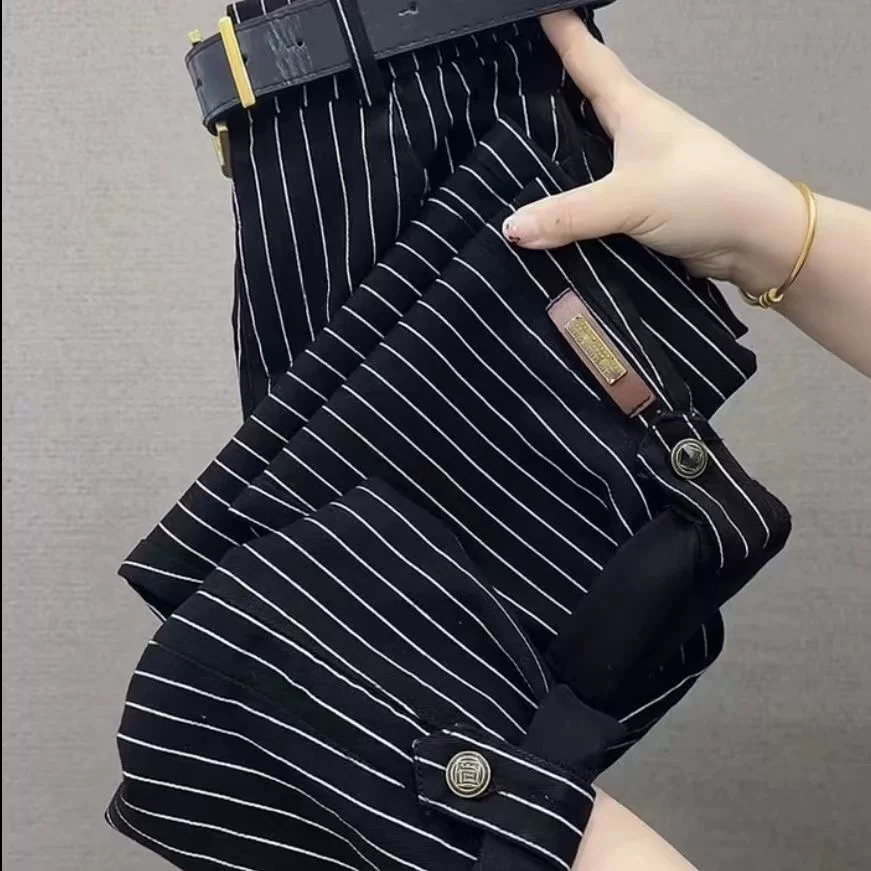 Black pinstripe pants showing cuff and pocket detailing