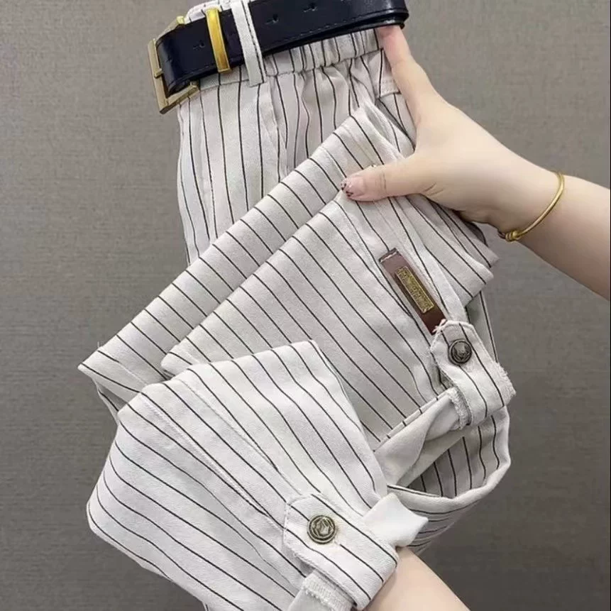 Light-coloured striped pants with belt loops and button-tab cuffs