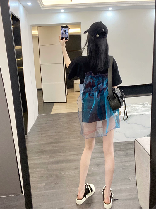 Back view of black oversized T-shirt with blue sheer overlay