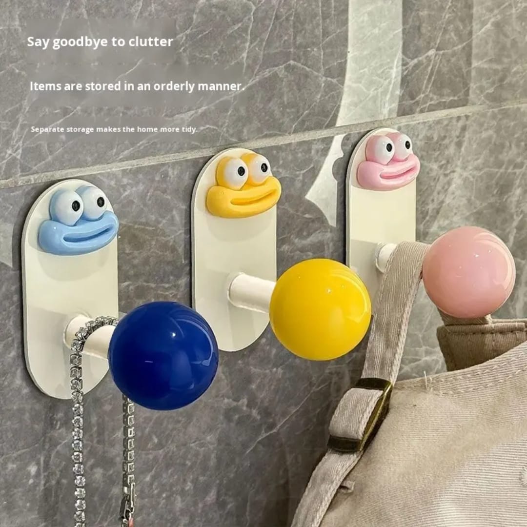 5 cartoon face wall hooks in different colours displayed on wall - Red, Pink, Yellow, Blue