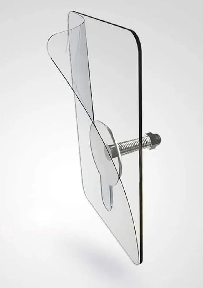Adhesive clip mounted on wall holding a shelf bracket